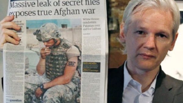  WikiLeaks founder Julian Assange holds up a copy of the Guardian after thousands of US military documents were leaked and exposed.