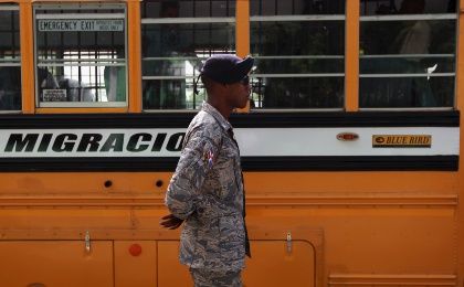 Un soldado dominicano hace guardia en uno de los autobuses de la Oficina Nacional de Migración en Santo Domingo, 24 de junio de 2015. 