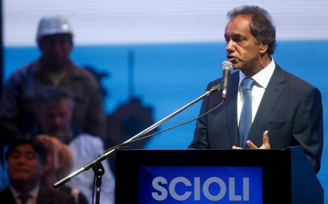 Daniel Scioli, Buenos Aires' province governor and presidential candidate for the Victory Front, speaks as vice-presidential candidate Carlos Zannini (bottom, L) watches during a campaign rally in Buenos Aires, September 21, 2015.