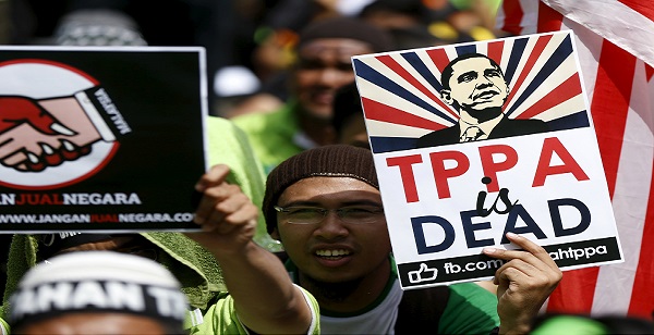 Protestors wave placards at a rally against the Trans Pacific Partnership (TPP) in Kuala Lumpur, Malaysia, Jan. 23, 2016.