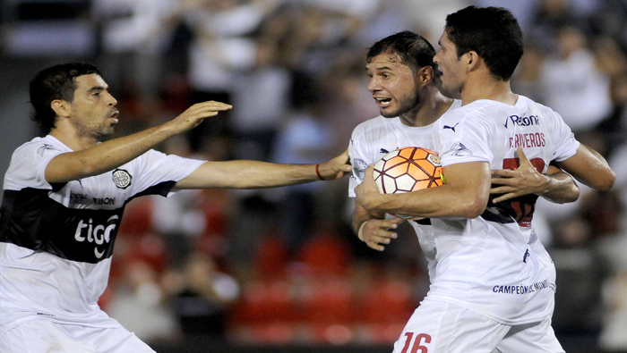 Julián Benítez (i), Fredy Bareiro (c) y Cristian Riveros (d) de Olimpia celebran el gol de este último ante Emelec.