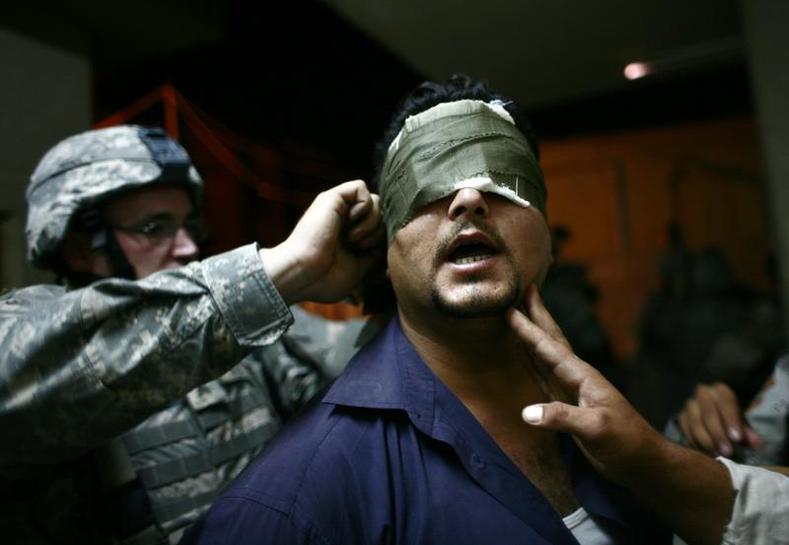 U.S. soldiers blindfold an Iraqi man after arresting him during a night patrol at the Zafraniya neighborhood, southeast of Baghdad September 4, 2007.