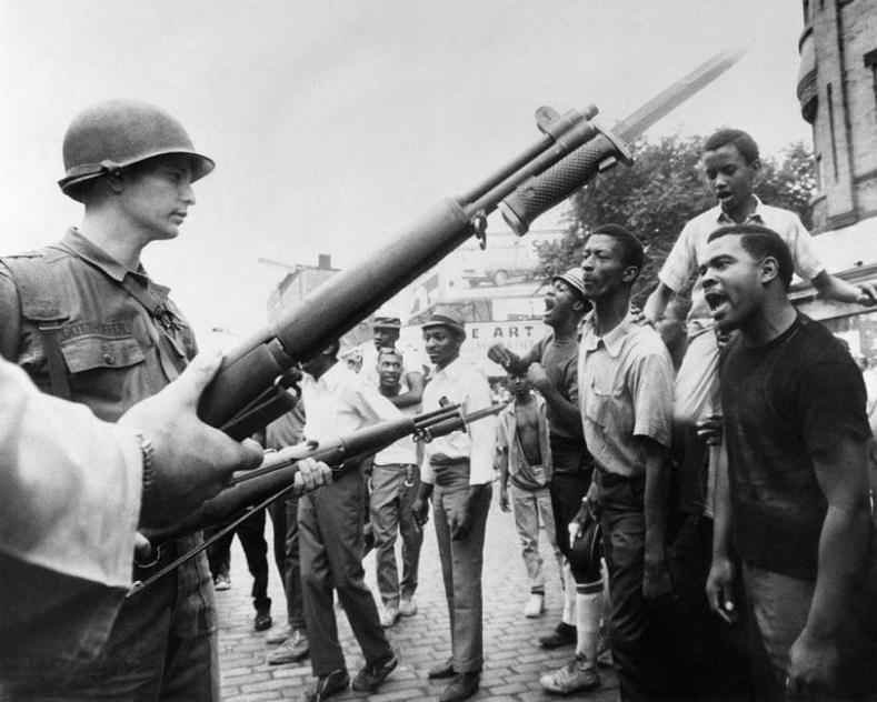 The attitude and phrase "Black power" signaled a massive radicalization of Black people within the United States, whose patience was stretched to the breaking point by racist repression, systemic neglect and abuse. Black demonstrators face armed federal soldiers in Newark, N.J., on July 17, 1967, during riots that erupted following a police operation. Unrest in cities across the U.S. in 1967 led President Johnson to strike the National Advisory Commission on Civil Disorders, also known as the Kerner Commission.