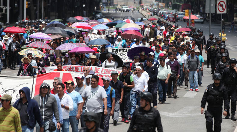 CNTE teachers march to join the sit-in against the neoliberal educational reforms of Enrique Peña Nieto.