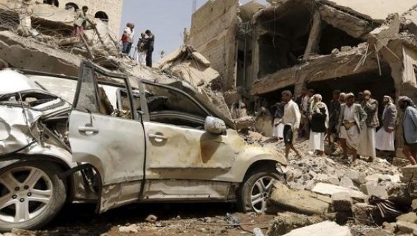 People gather at the site of a Saudi-led air strike in Yemen