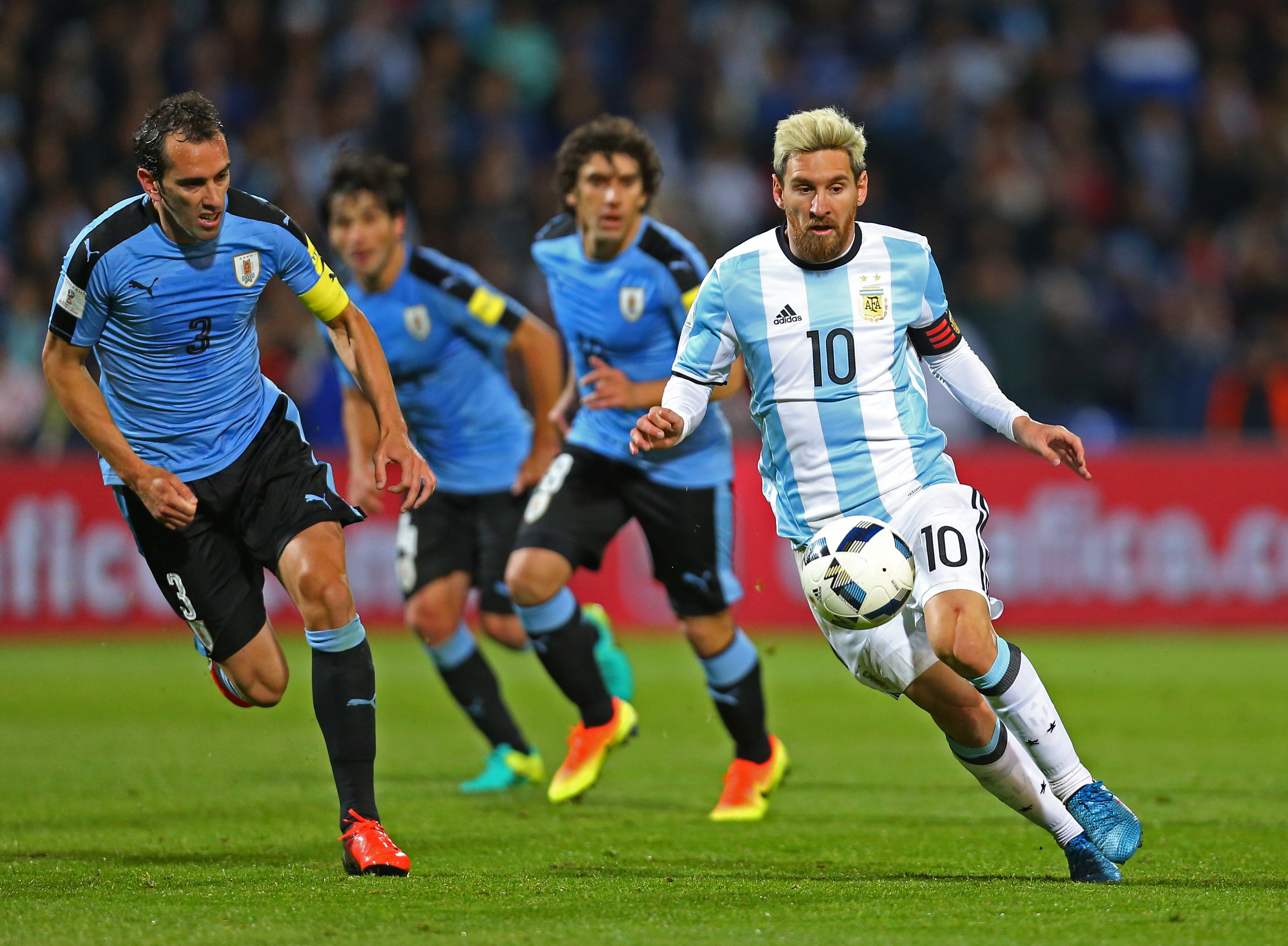 Messi (d) de Argentina disputa un balón con Diego Godín (i) de Uruguay