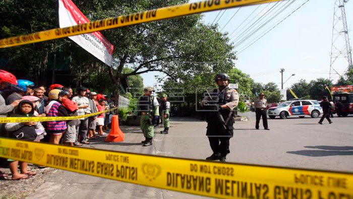 Policías indonesios vigilan tras un ataque suicida con bomba en la sede de la policía en Surakarta.