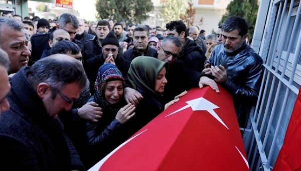 Relatives of Fatih Cakmak, a security guard and a victim of an attack by a gunman at Reina nightclub, react during his funeral in Istanbul, Turkey, Jan. 2, 2017. 