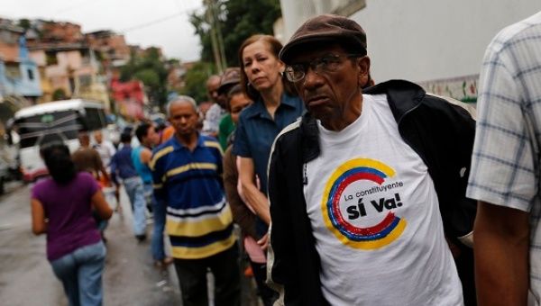 People wait to cast their vote at a polling station during the Constituent Assembly election in Caracas.