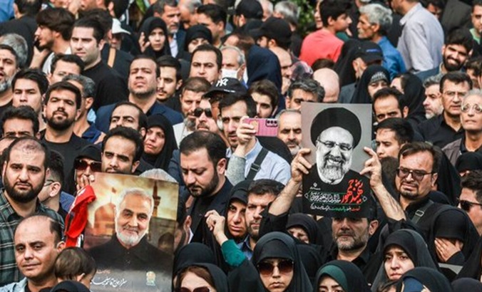 Iranians accompany the funeral procession of President Ebrahim Raisi, May 21, 2024.
