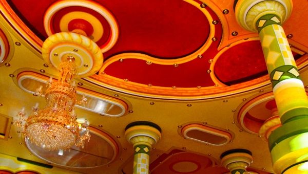 Bright colors and a lavish chandelier distinguish this ballroom ceiling