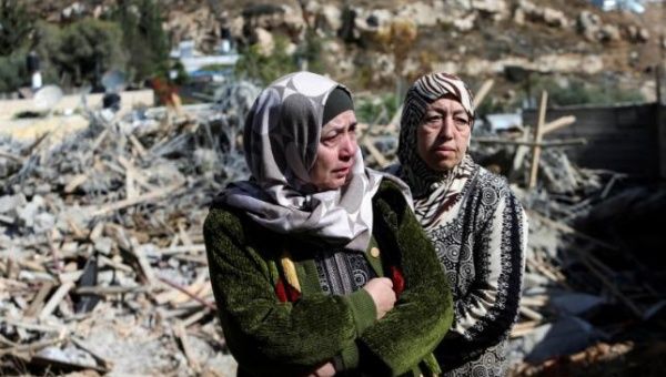 A Palestinian woman stands by the rubble of her home in East Jerusalem after it was demolished on the orders of the Israel state.