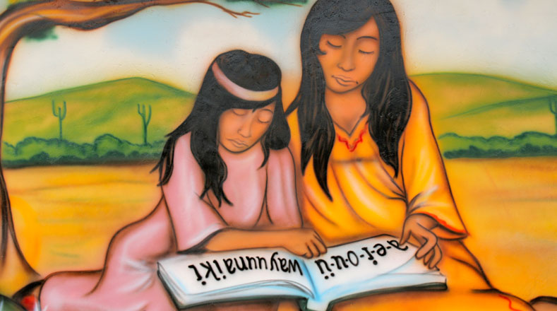 Mural de dos indígenas wayúu estudiando ubicado en la escuela de El Tigre, en La Guajira venezolana.