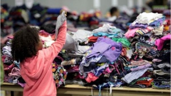 A child looks at donated clothes at a convention centre for Caribbean refugees whose homes were destroyed by Hurricane Irma, in San Juan, Puerto Rico.