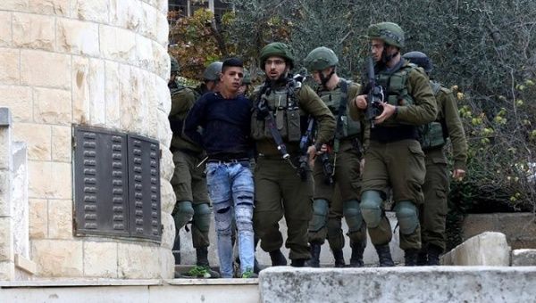 A young Palestinian boy is arrested by Israeli forces near Nablus.