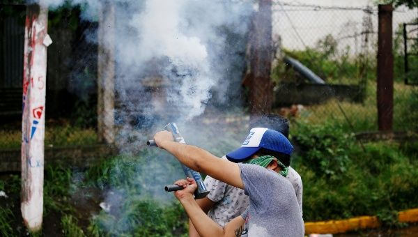 A demonstrator holds a homemade mortar during a protest against Nicaraguan President Daniel Ortega