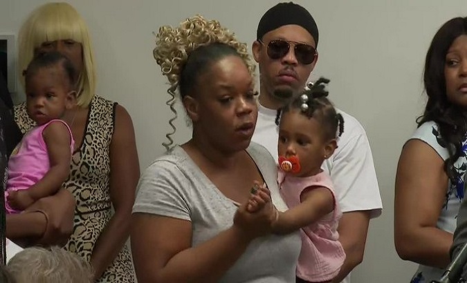 NO FILM, NO VIDEO, NO TV, NO DOCUMENTARY - Tomika Miller, the wife of  Rayshard Brooks, holds their daughter Memory, 2, while attorney Chris  Stewart speaks during the family press conference on