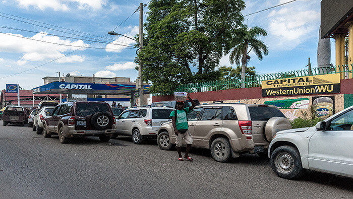 Personas hacen fila para abastecer sus vehículos con gasolina en la capital de Haití.