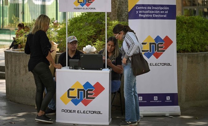 Venezuelans verify their data at a stand of the National Electoral Council.